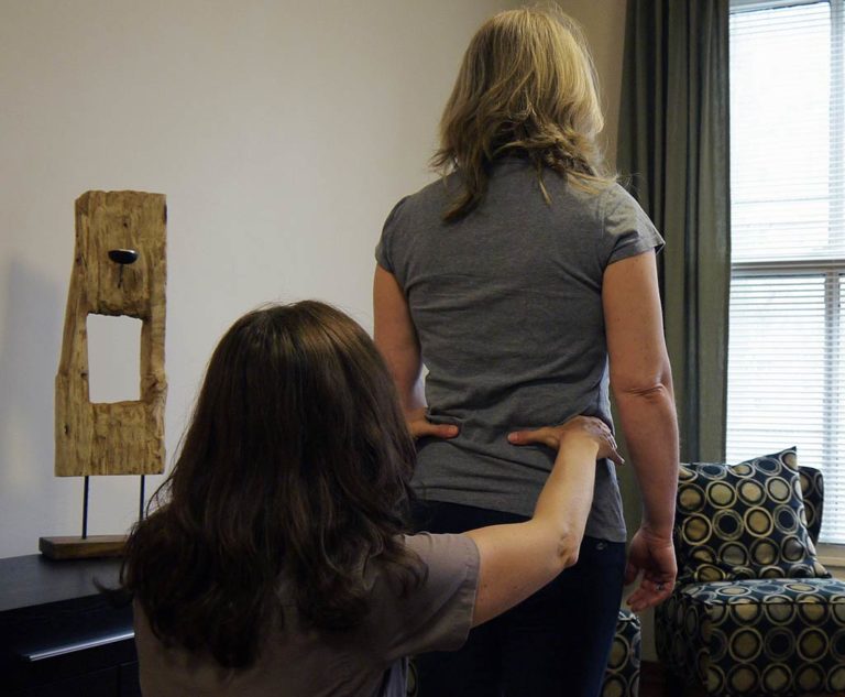 Anie Rodier performing a posture evaluation in Victoria to treat the whole body